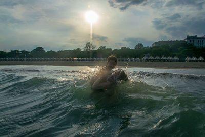 Mother and daughter swimming in sea