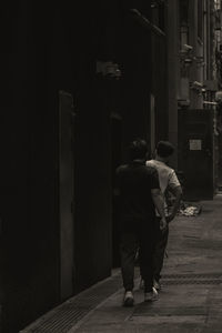 Rear view of man walking in tunnel