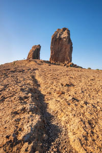 Low angle view of rock formations against sky