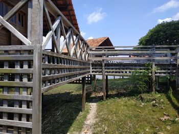 Bridge amidst trees and buildings against sky