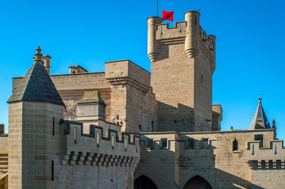 Flag waving on fort against sky