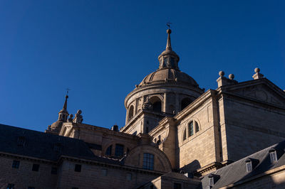 Low angle view of building against clear blue sky