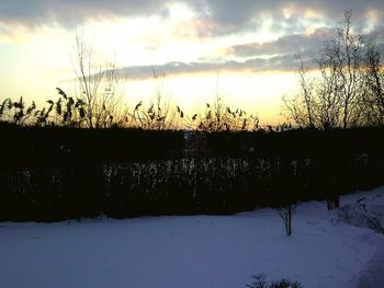 Scenic view of lake against sky during winter