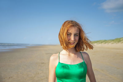 Young woman standing at beach