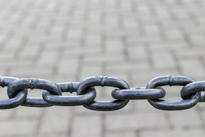 Close-up of chain on metal fence