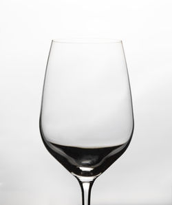 Close-up of wineglass against white background