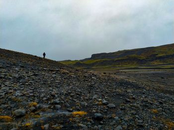 Scenic view of man on landscape against sky