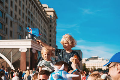Group of people in front of buildings