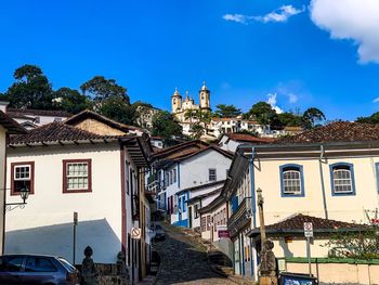 Buildings in town against blue sky