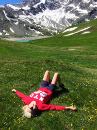 Midsection of woman lying down on field