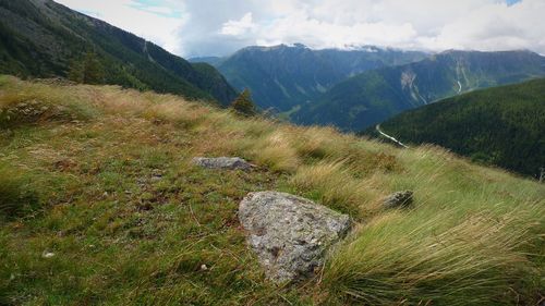 Scenic view of mountains against cloudy sky