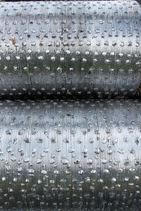 Full frame shot of wet metal grate