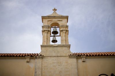 Low angle view of bell tower against sky