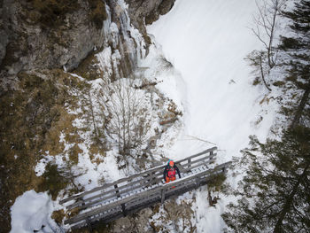 High angle view of snow by trees against mountain