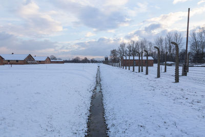 Snow covered field against sky