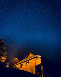 Low angle view of illuminated building against sky at night