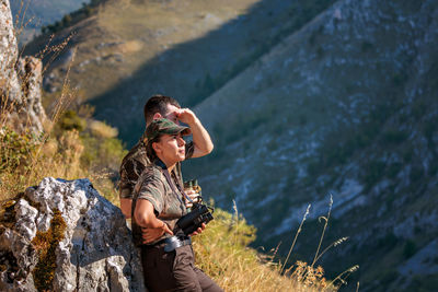 Side view of woman standing on rock