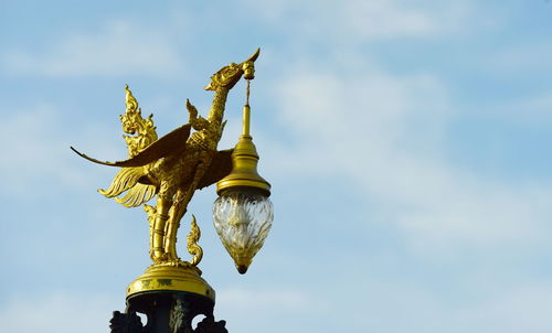 Low angle view of angel statue against sky