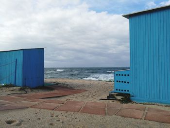 Lifeguard hut on beach against sky