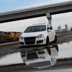 Cars on bridge against sky