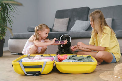 Portrait of smiling girl playing with teddy bear