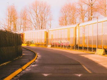 Train cars beside the road