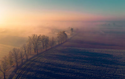 Scenic view of field against sky during sunset