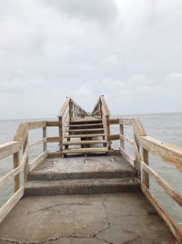 Pier over sea against sky