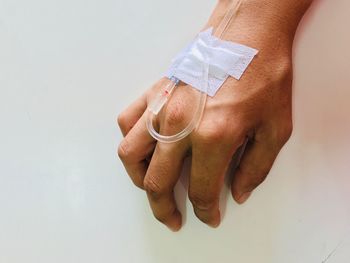 Close-up of hand over white background