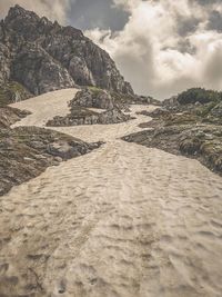 Surface level of sandy beach against sky