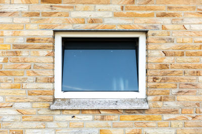 Low angle view of window on wall of house