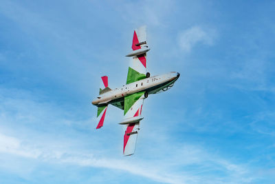 Low angle view of airplane flying against sky