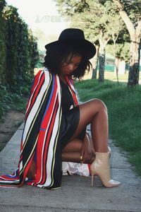 Young woman sitting on tree