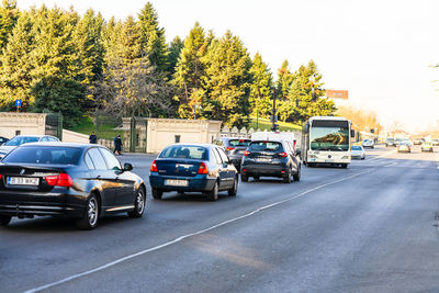 Cars on street in city against sky