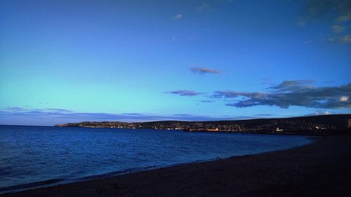 Scenic view of sea against blue sky