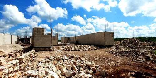 Built structure on field against sky