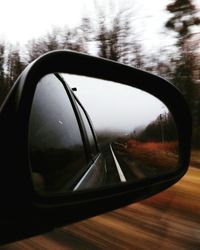 Reflection of car on side-view mirror