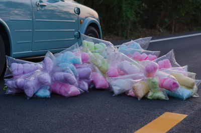 Close-up of multi colored cotton candies on road