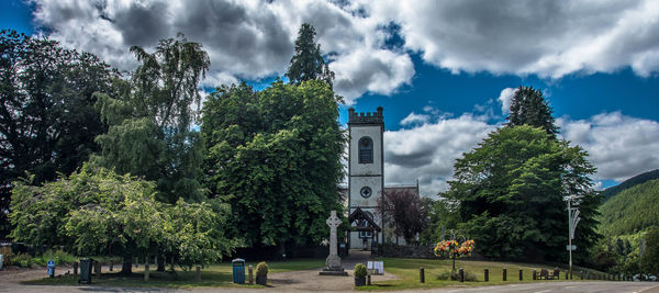 Panoramic view of trees and buildings against sky