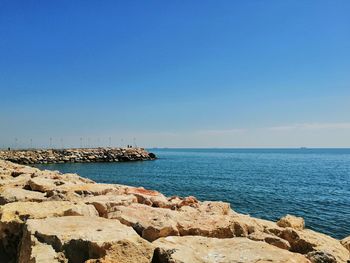 Scenic view of sea against clear blue sky