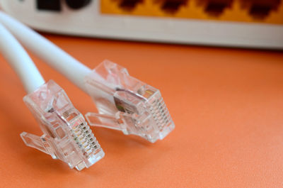 Close-up of computer network cables and router on table