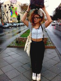 Full length portrait of woman standing in park