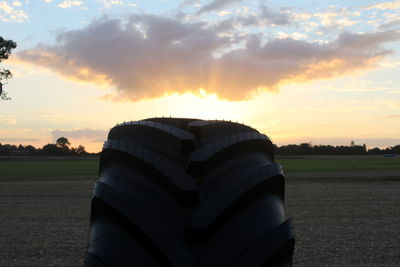 Scenic view of field at sunset