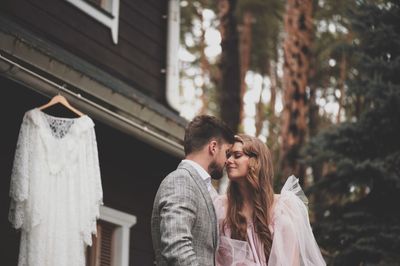 Wedding couple falling in love by house