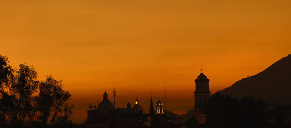 Silhouette of buildings against sky during sunset