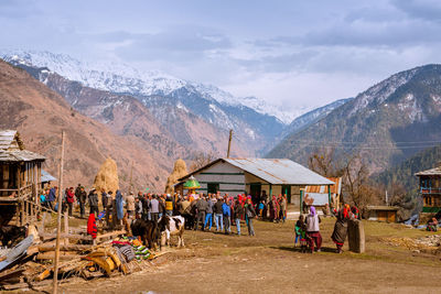 Group of people on mountain road against sky