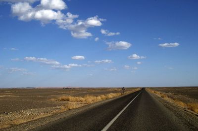 Empty road along countryside landscape