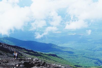 Scenic view of sea and mountains against sky