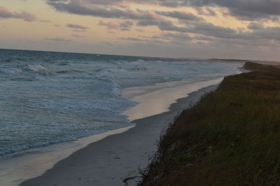 Scenic view of beach against sky during sunset