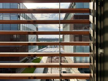 Low angle view of glass building against sky